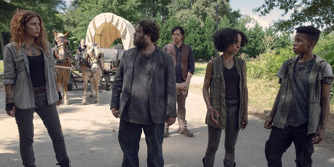 Magna, Luke, Connie, and Kelly look at one another, Eugene behind them in The Walking Dead.