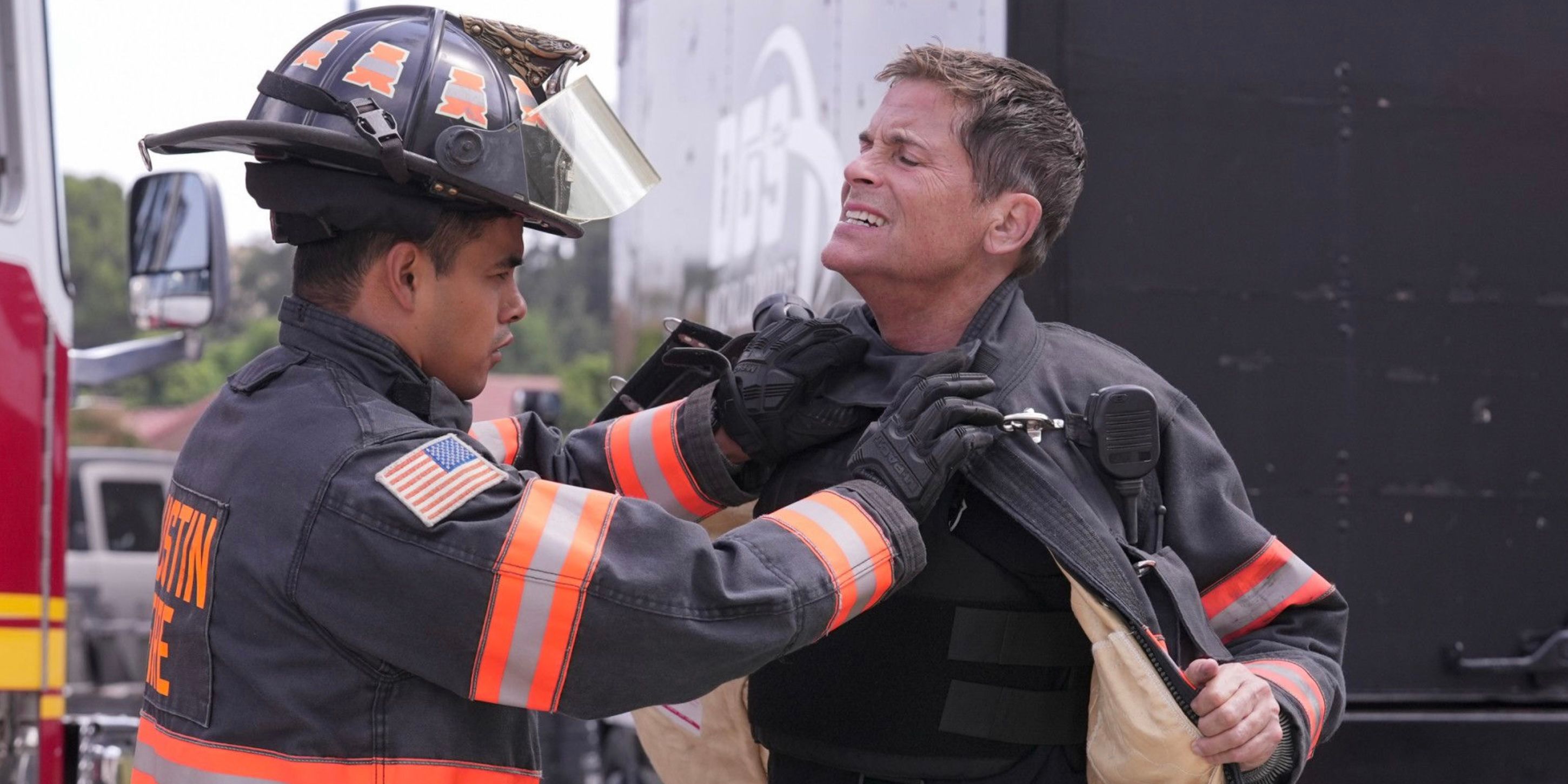 Mateo Chavez (Julian Works) checking Owen Strand (Rob Lowe) next to a fire truck on 9-1-1 Lone Star