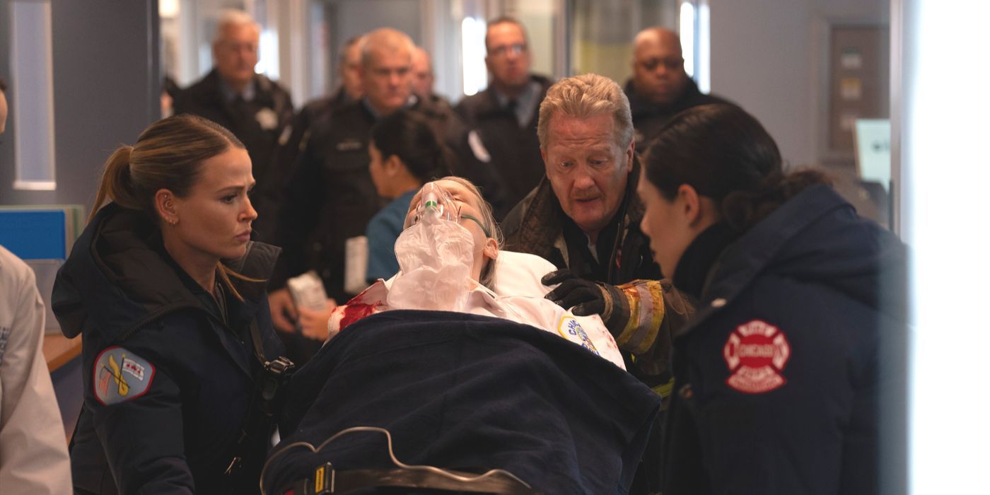 Trudy Platt on a gurney, surrounded by paramedics and Mouch, with police behind them on Chicago Fire