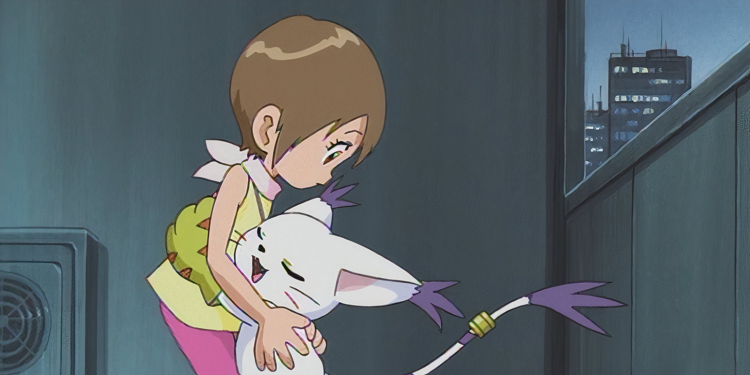 Kari abraça Gatomon em Digimon Adventure.