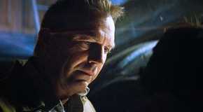 Kevin Costner as Jonathan Pa Kent in the barn basement looking at young Clark from the Man of Steel movie