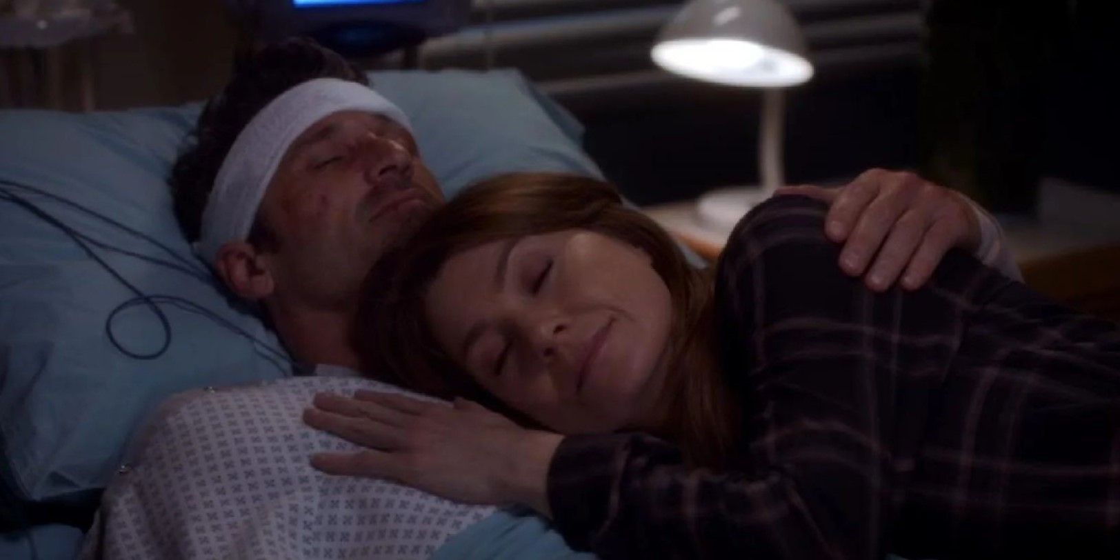 Meredith Grey lies with Derek Shepherd in his hospital bed in Grey's Anatomy.