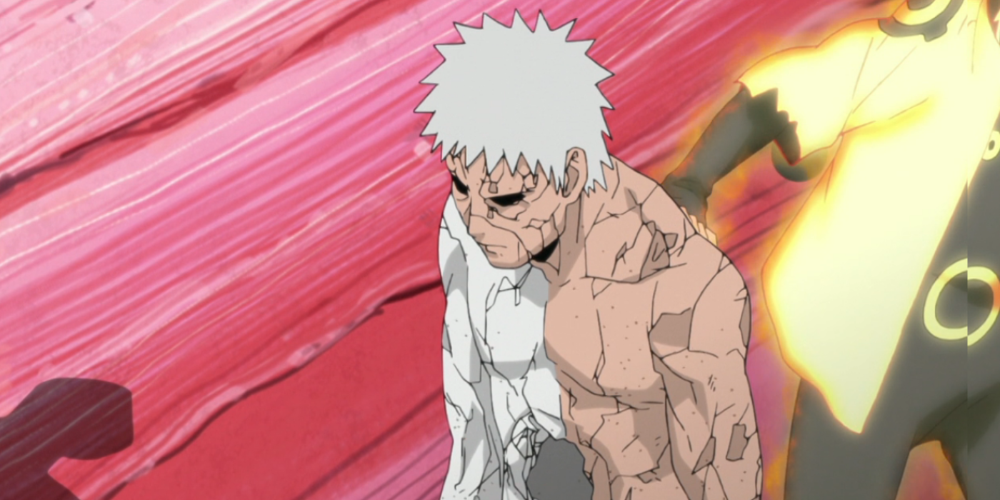 Obito Uchiha's eyes are shadowed as he dies after taking a blow meant for Naruto Uzumaki in Naruto: Shippuden.