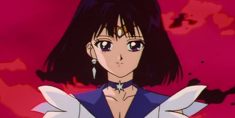 Sailor Saturn smiling against a red sky in the anime Sailor Moon.