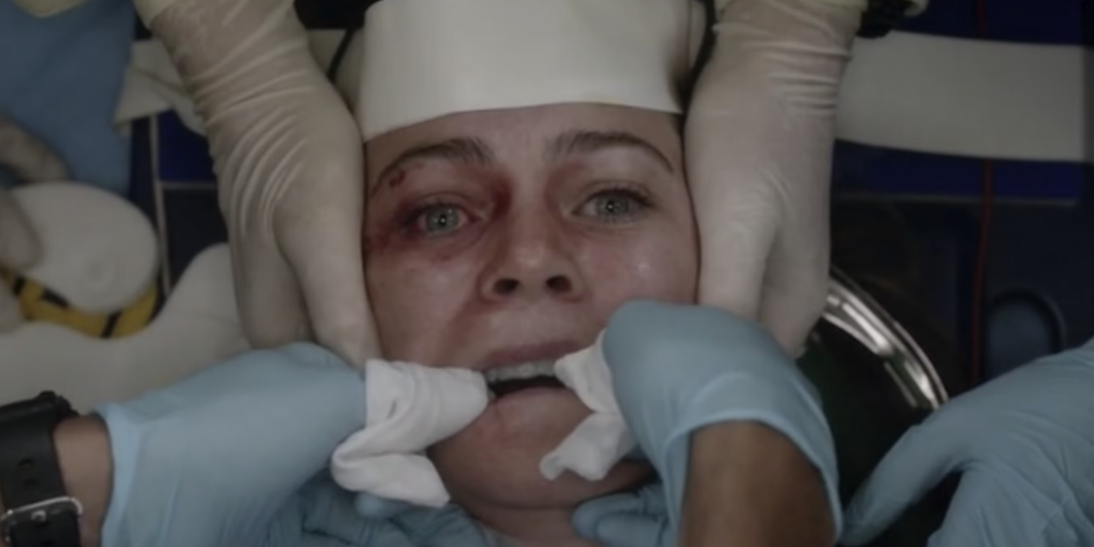 A closeup shows an injured Meredith as doctors are working on her in Grey's Anatomy.