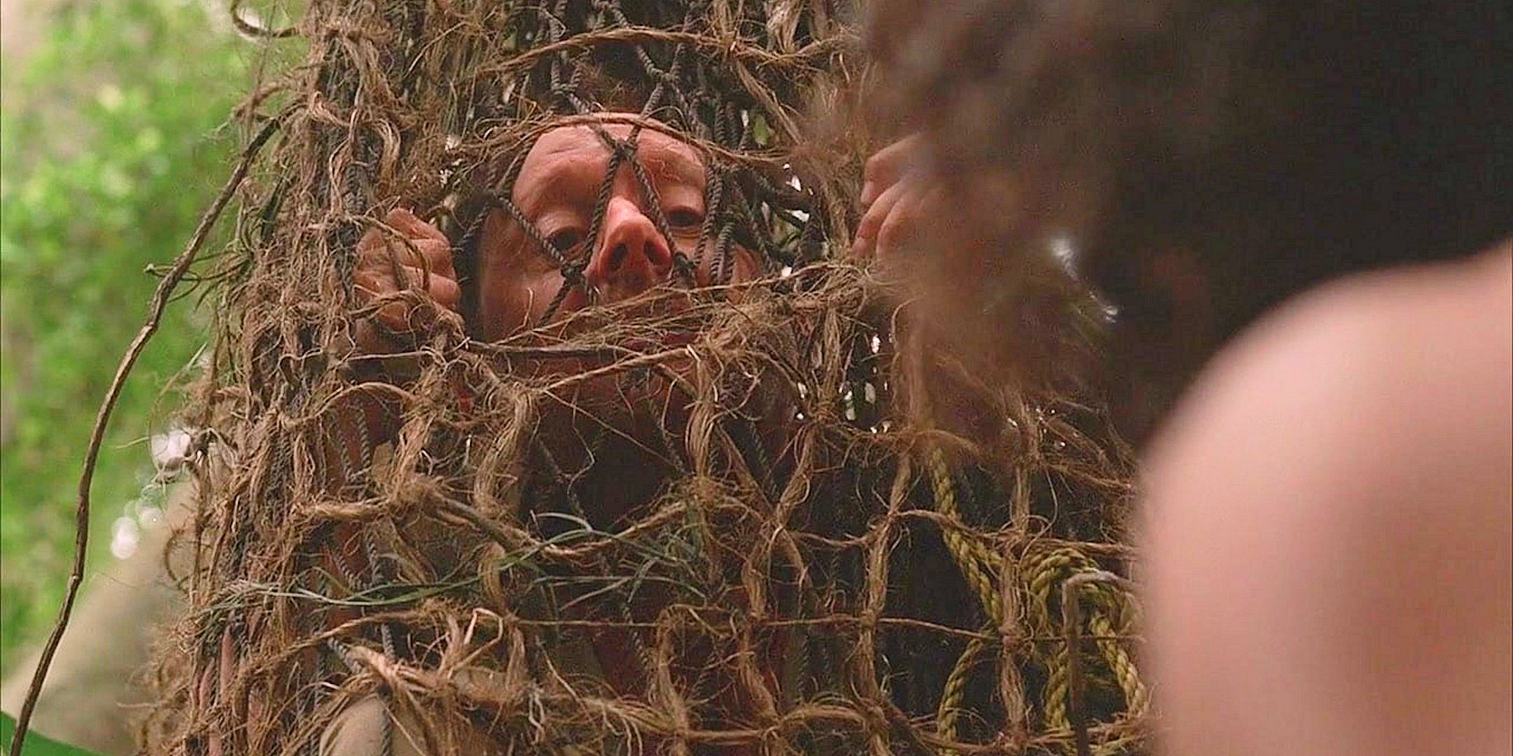 Ben Linus as Henry Gale peering through a net hanging in the jungle on the lost series