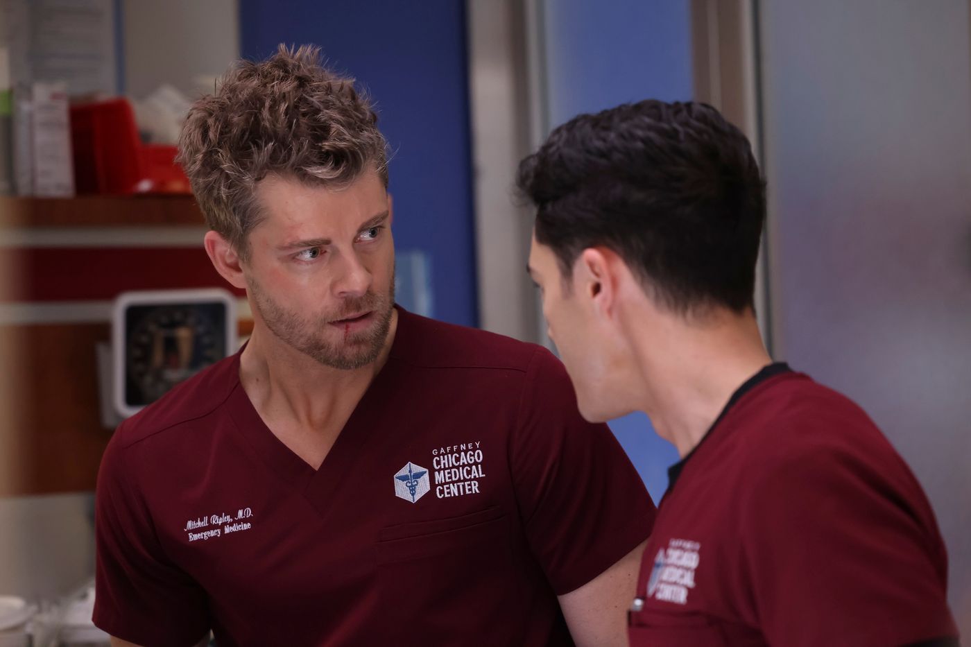 Mitch Ripley (Luke Mitchell) looks at Dr. John Frost (Darren Barnet), back to camera, on Chicago Med