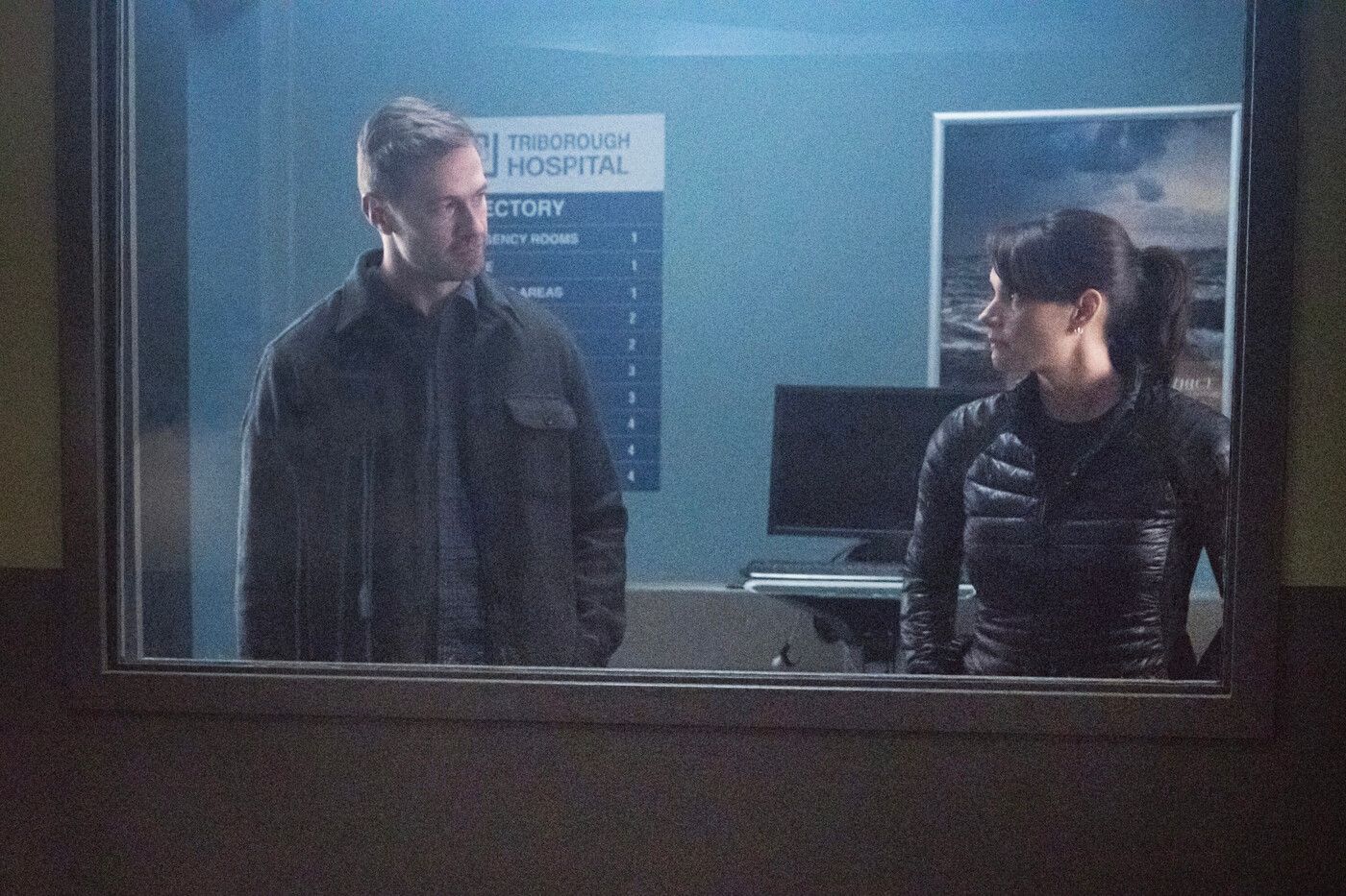 Joel (Bill Barrett) and Maggie (Missy Peregrym) look at each other outside a hospital room in FBI