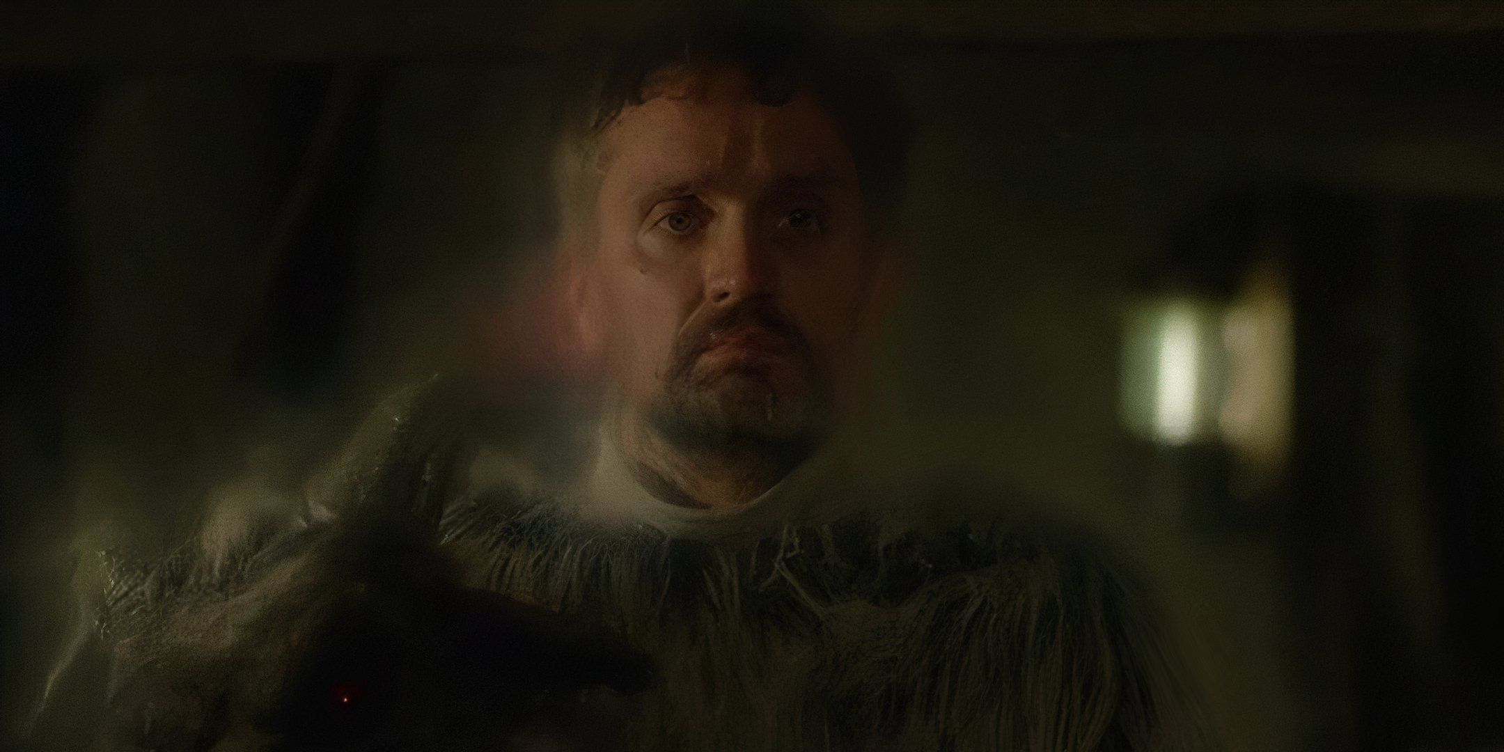 George Kyle Peters wearing a goat costume and holding his mask with an aura around him in Criminal Minds Rusty.