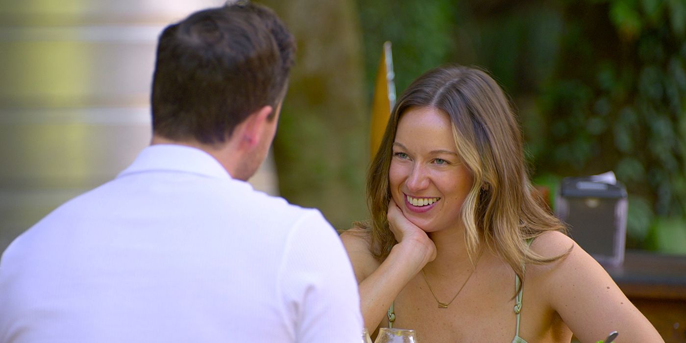 Lauren smiling at Dave while eating on a patio in Love Is Blind.