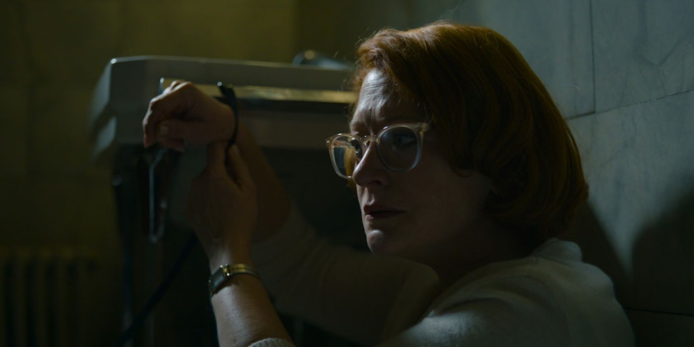 Dolores restrained by Michael Fassbender's assassin in The Killer