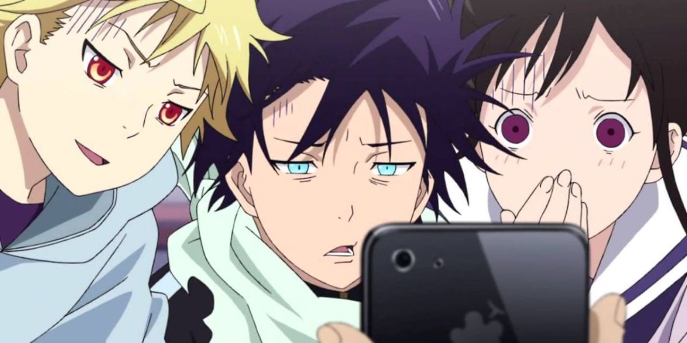 Yato, Yukine and Hiyori look shocked at something they're viewing on a phone in Noragami.