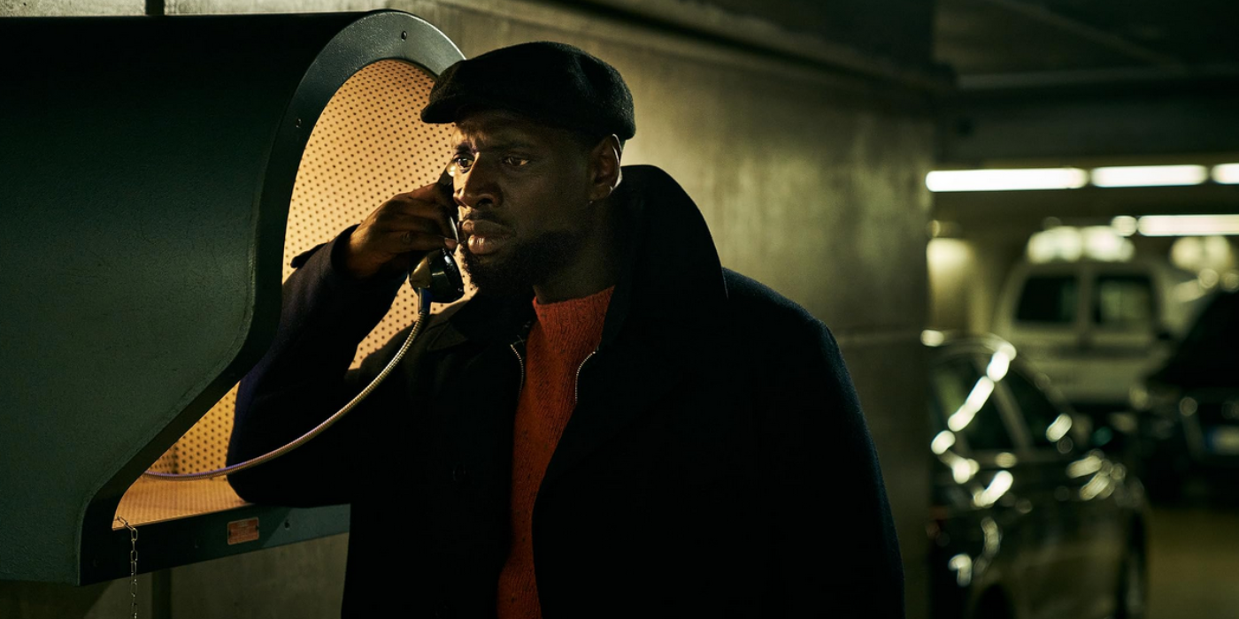 Assone Diop (Omar Sy) is on the phone in Lupin (2021).