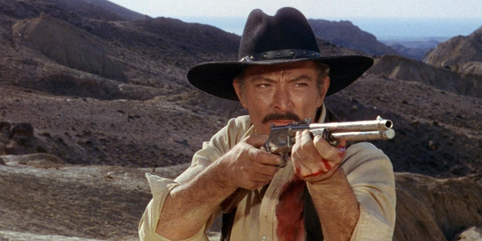 Lee Van Cleef, Big Gundown'da dışarıda bir tüfek tutar.