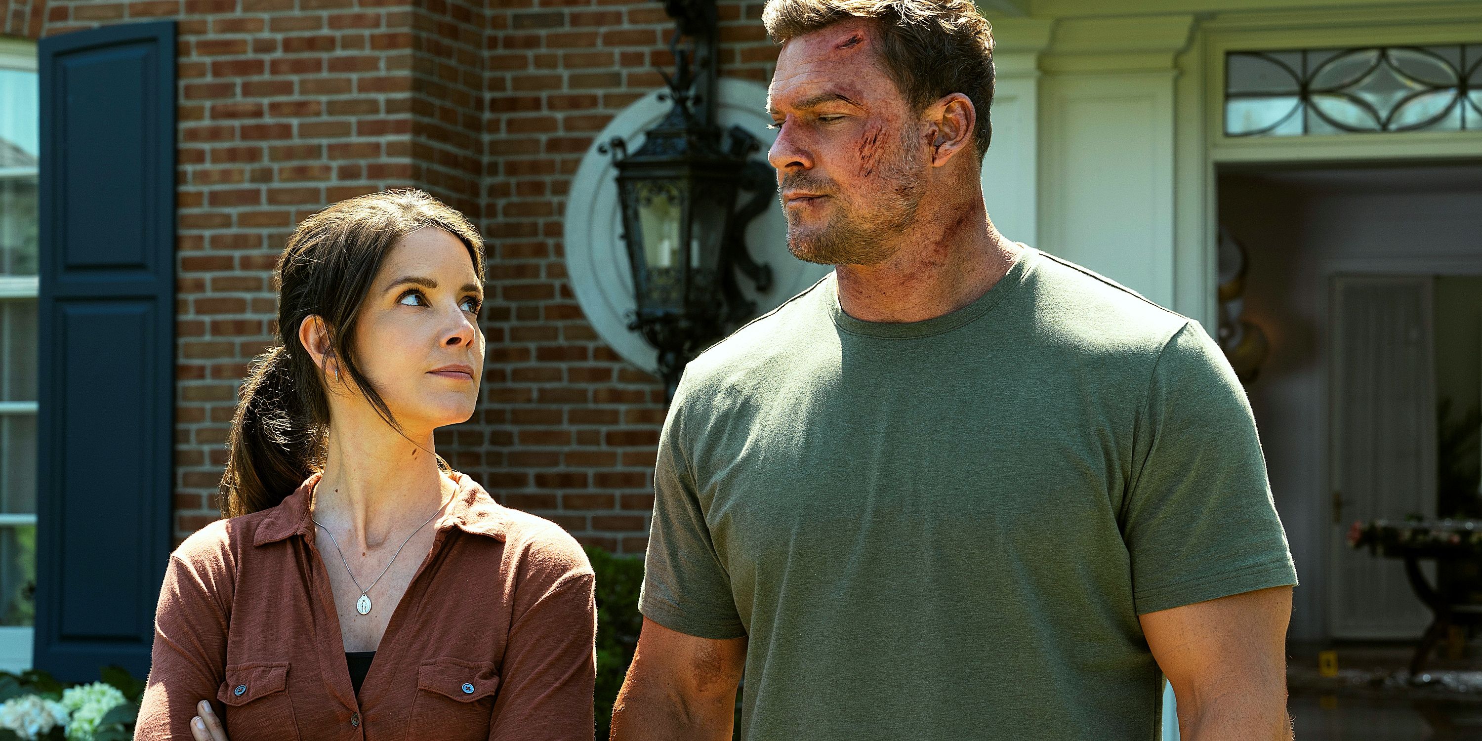 Susan Duffy and Jack Reacher, in dirty clothes with superficial injuries, standing in front of a reacher area