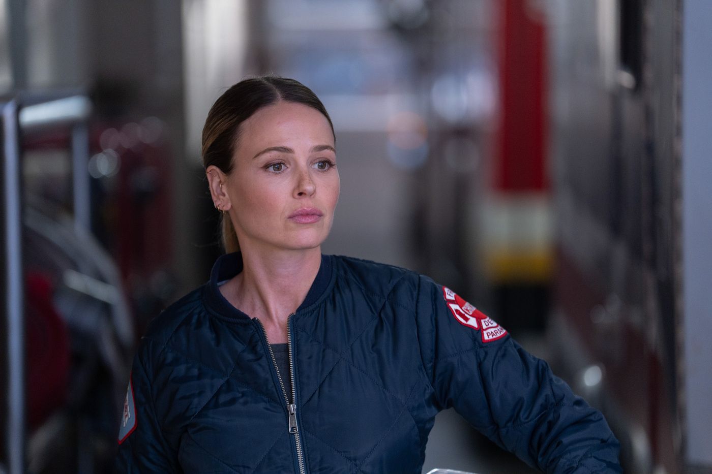 Lizzie Novak, played by actor Jocelyn Hudon, wearing a blue paramedic jacket on Chicago Fire