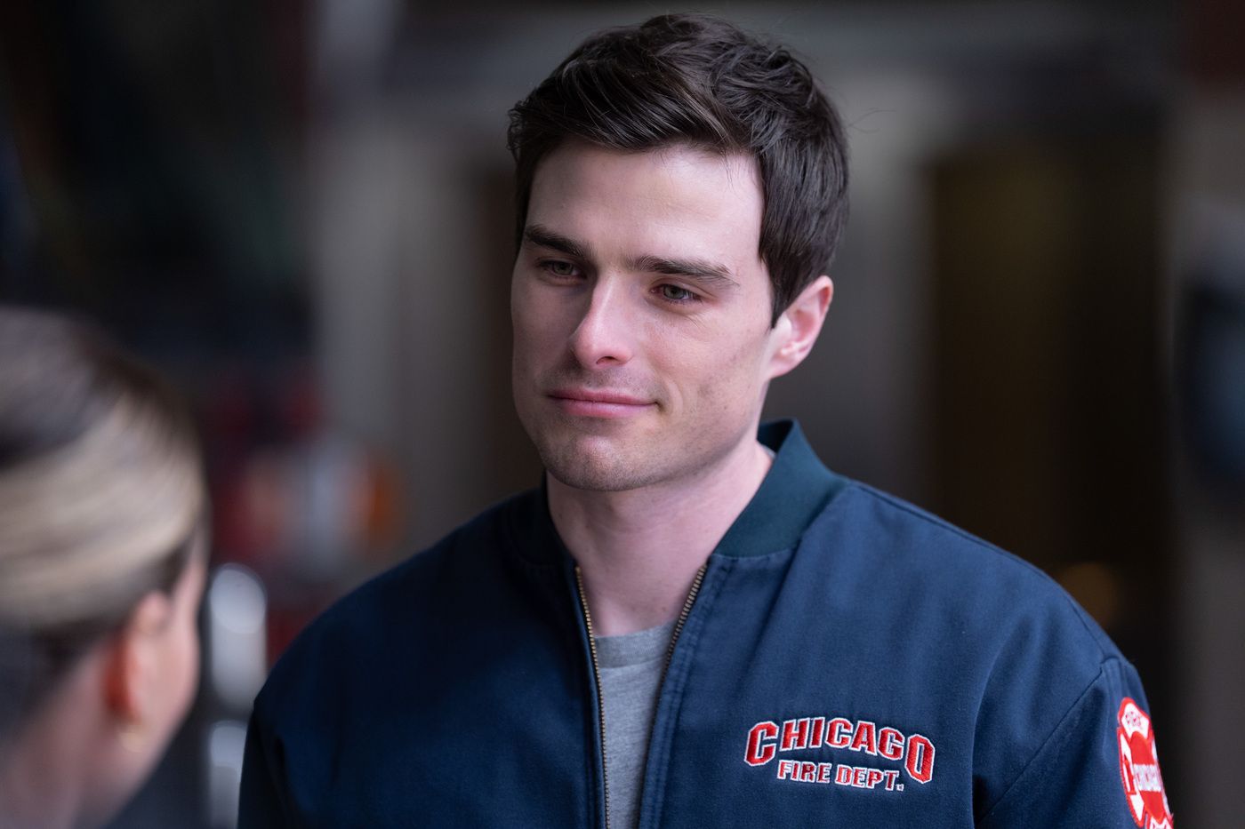 Jack Damon, played by Michael Bradway, wearing a blue Chicago Fire Department jacket on Chicago Fire