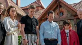 The cast of the movie Death of a Unicorn, all standing in a line looking down outside a mansion