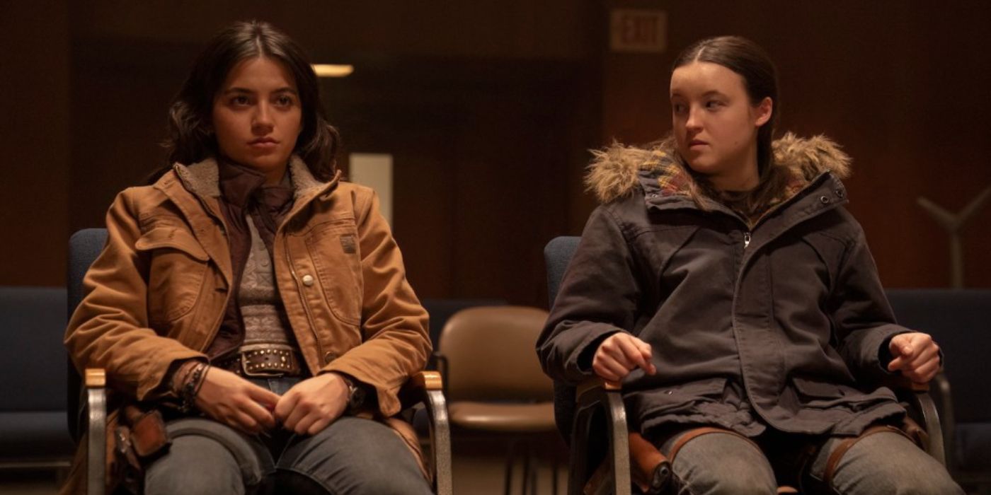 Dina wearing a brown jacket and Ellie wearing an olive coat sit in chairs in The Last of Us Season 2