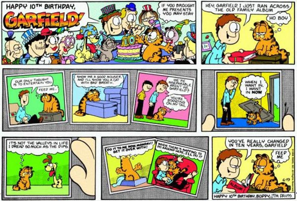 Garfield and Jon look at a photo album