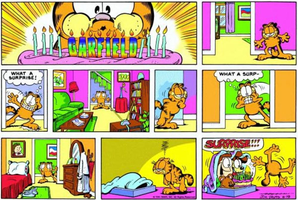 Jon and Odie surprise Garfield in his bed.