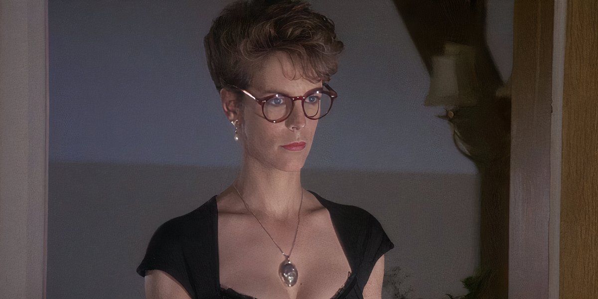 Jamie Lee Curtis in A Fish Called Wanda wearing glasses and wearing a locket