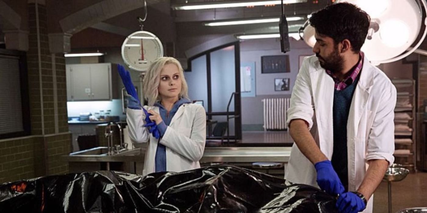 Liv Moore (Rose McIver) is talking with Ravi Chakrabarti (Rahul Kohli) as they prepare to examine a body in iZombie, a CW show.