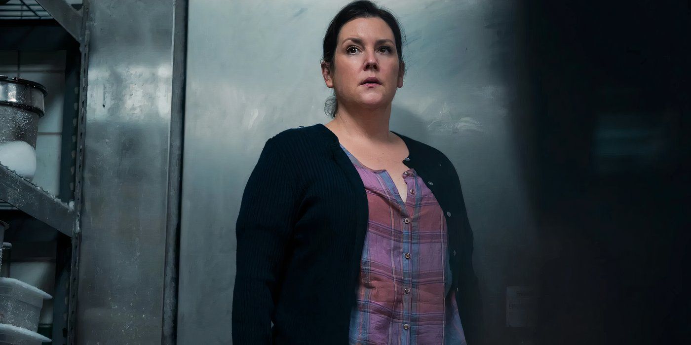 Shauna standing in a deep freezer, looking concerned