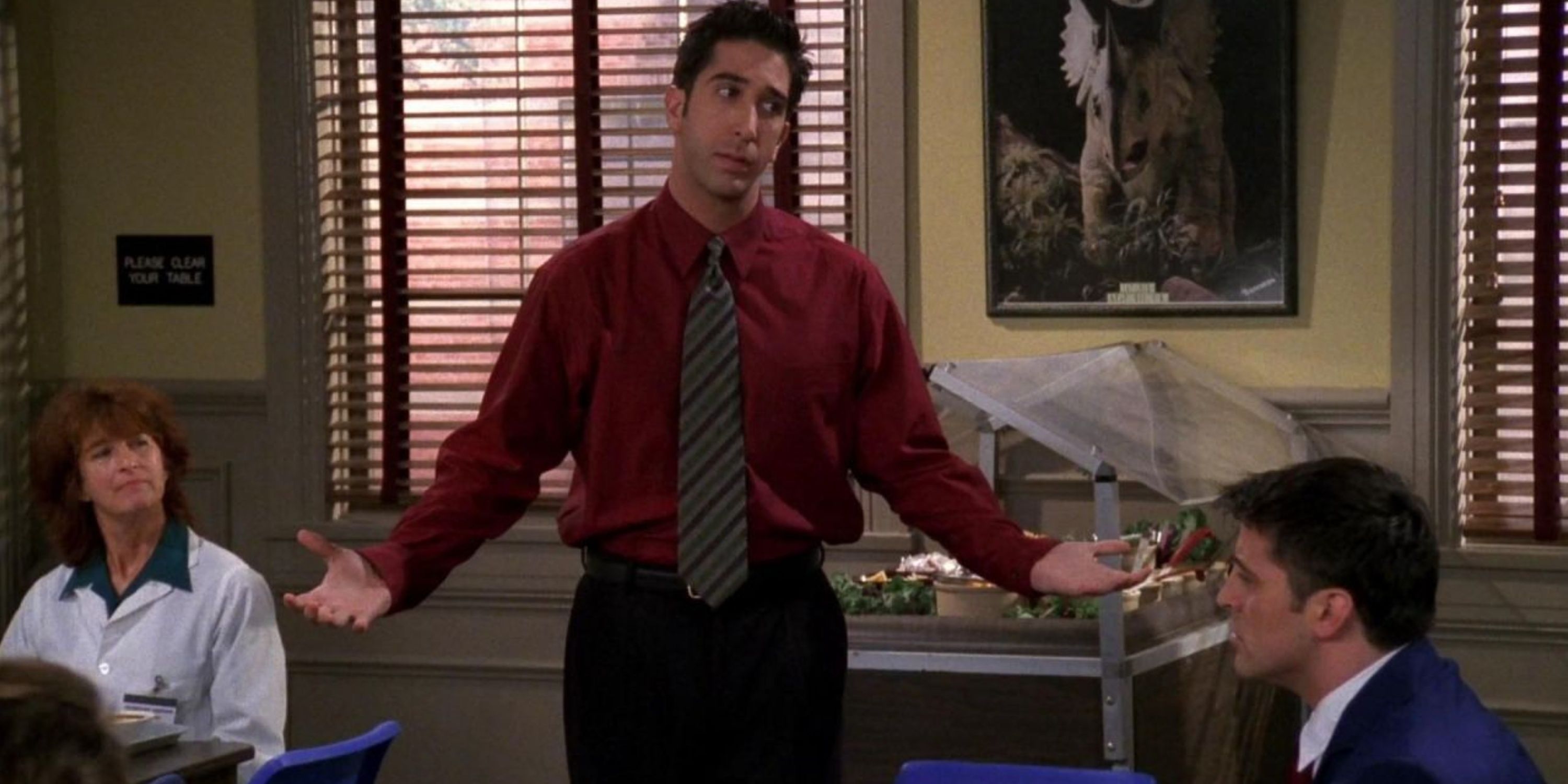 Ross stands with his hands out to his sides in Friends