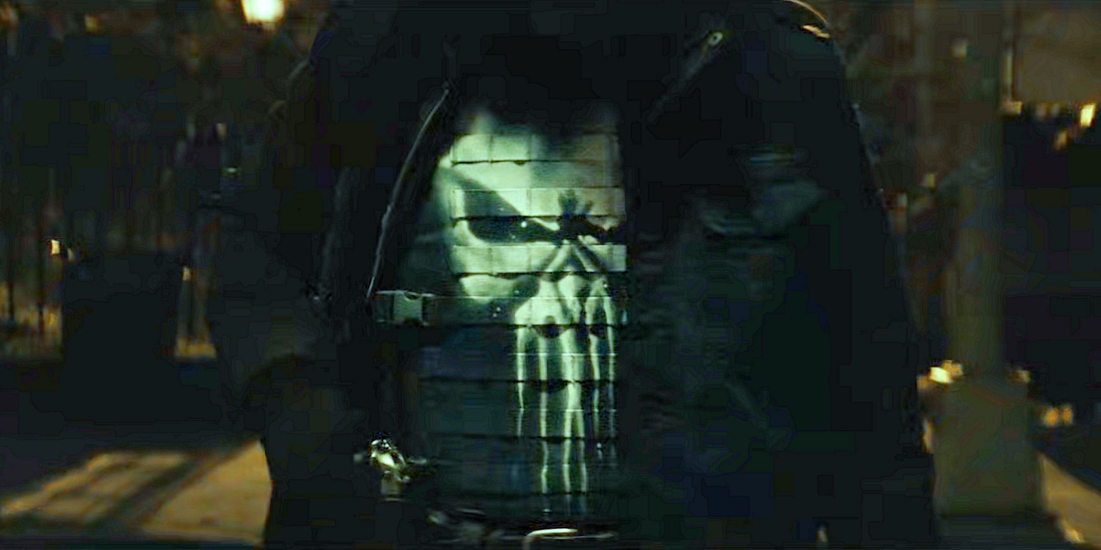 Street at night, hooded man face concealed walking towards camera the Punisher skill logo visible on his chest from Daredevil Born Again