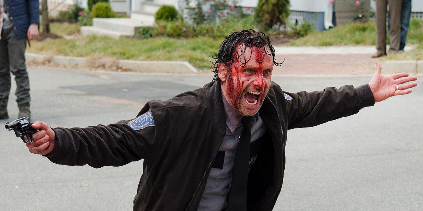 Rick in his sheriff uniform with a bloody face screaming and holding his arms out, one with a gun in The Walking Dead.