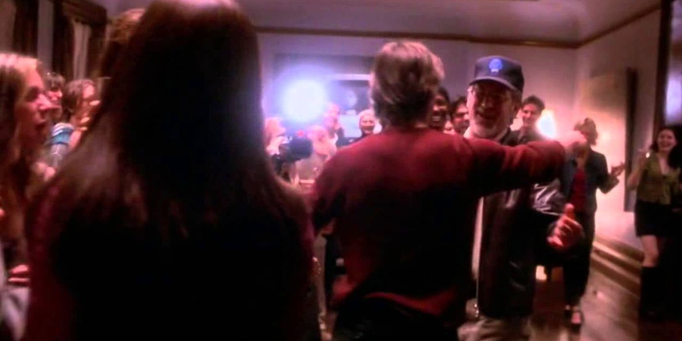 Tom Cruise as David Aames hugging Steven Spielberg at a party from Vanilla Sky