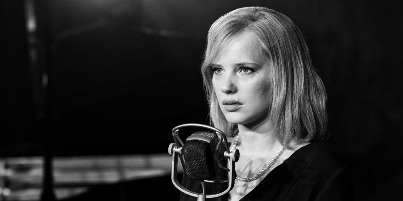 Zula standing in front of a microphone in The Cold War