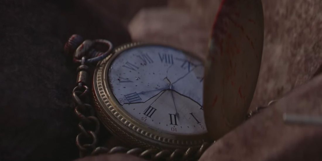 A bloody pocket watch rests in dirt in borrowed time.