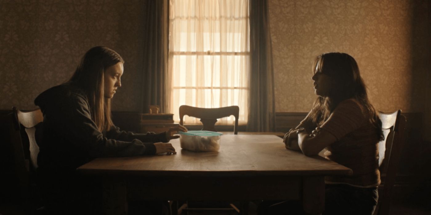 Dina telling Ellie what she knows about the WLF at a table at Joel's old house in The Last of Us