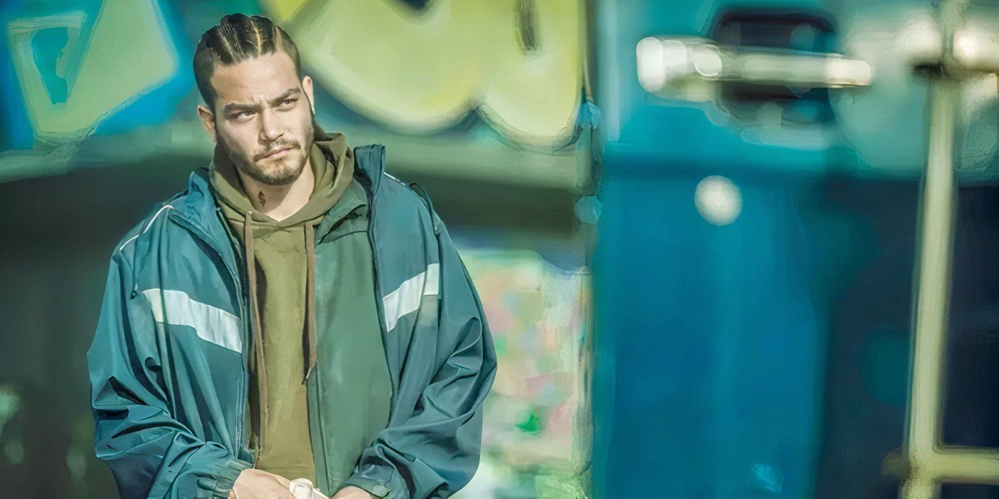 Money is standing outside of a building covered in graffiti in Don't Breathe