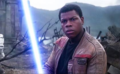 Finn (John Boyega) wields a lightsaber in Star Wars: The Force Awakens.