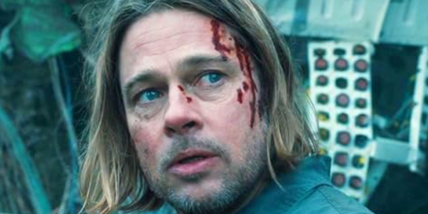 Gerry Lane (Brad Pitt) has blood dripping down his face and looks worried as he looks behind himself in World War Z.