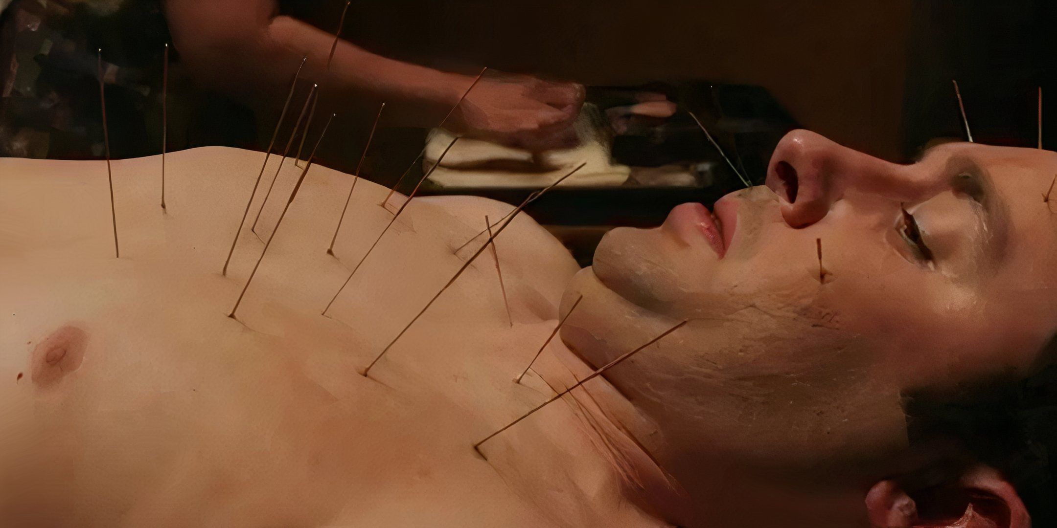 Isaac Palmer looking down at the acupuncture needles in his skin in Final Destination 5