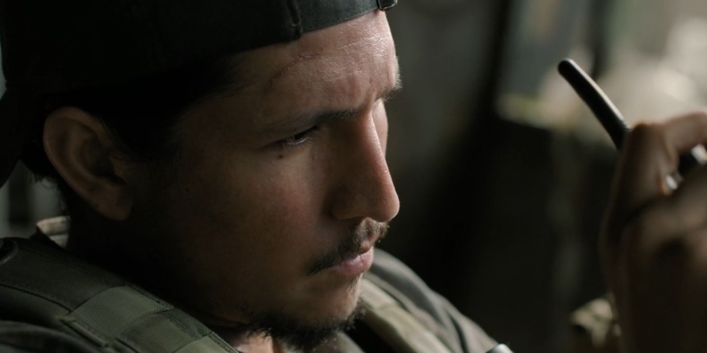 Manny talking to a walkie-talkie while stationed in his watch tower in The Last of Us