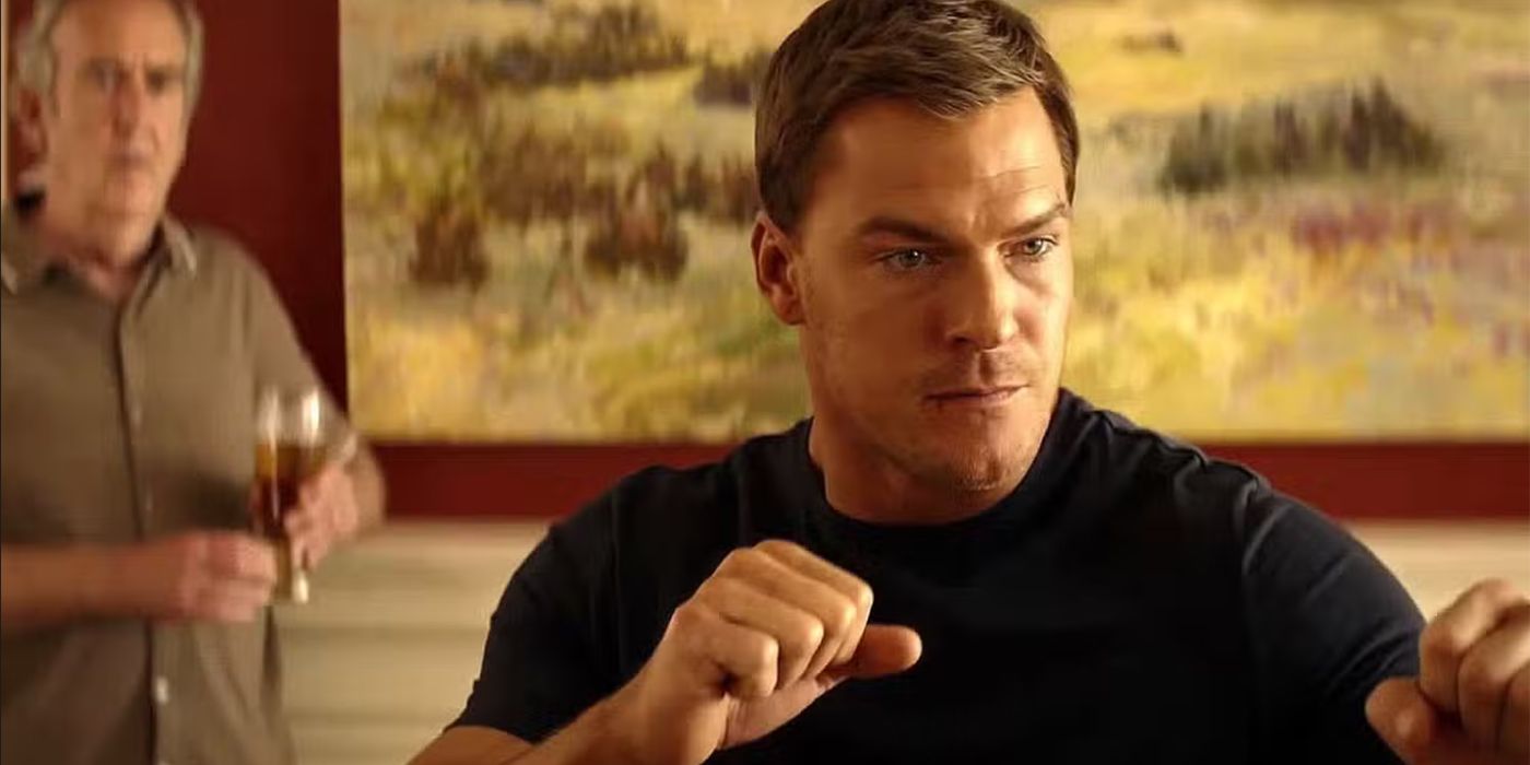 Reacher, in a black T-shirt, assumes a fighting stance as a man watches in background from Reacher