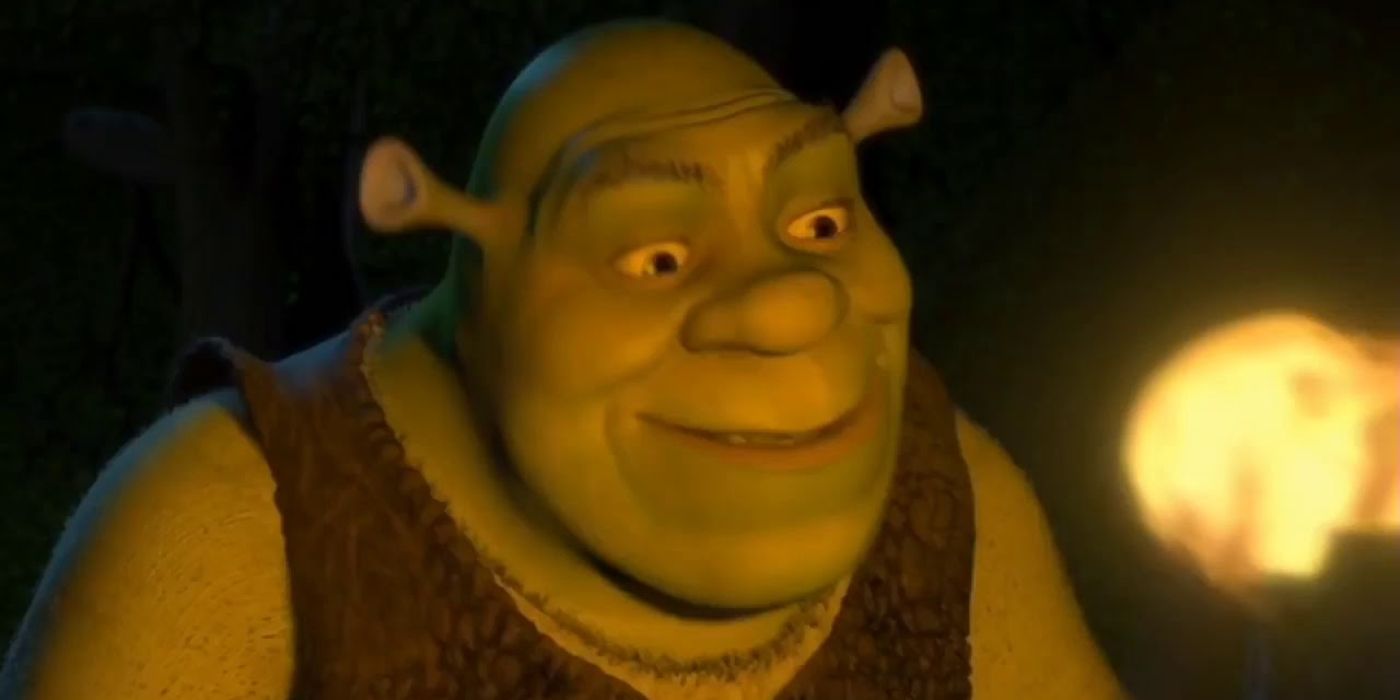 Shrek asustando a una multitud mientras tienen una antorcha en su cara en la primera película de Shrek