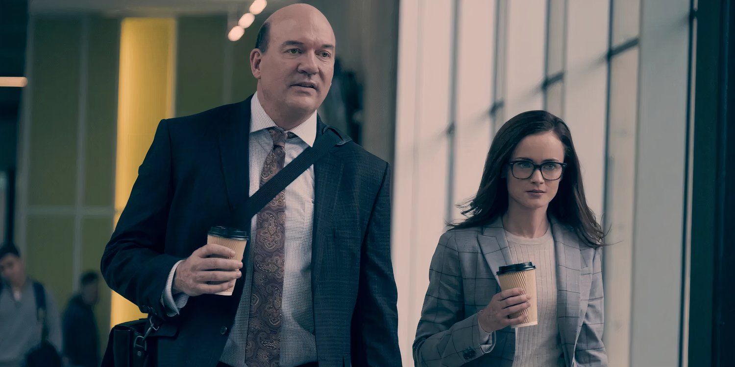 Emily walking with another professor, holding a cup of coffee