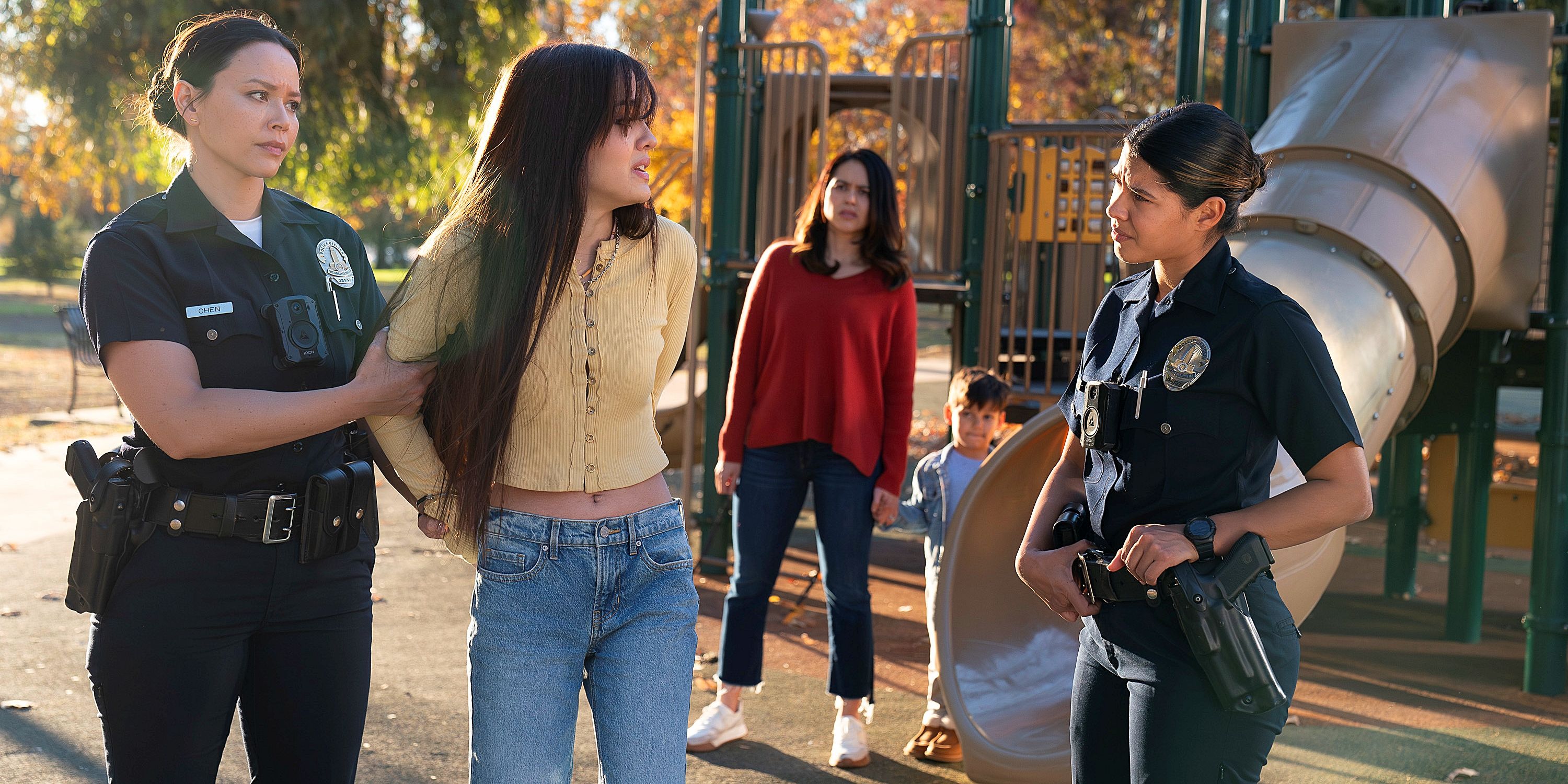 Lucy Chen and Celina Juarez in police uniform, speaking to a teenage girl, in the TV show The Rookie