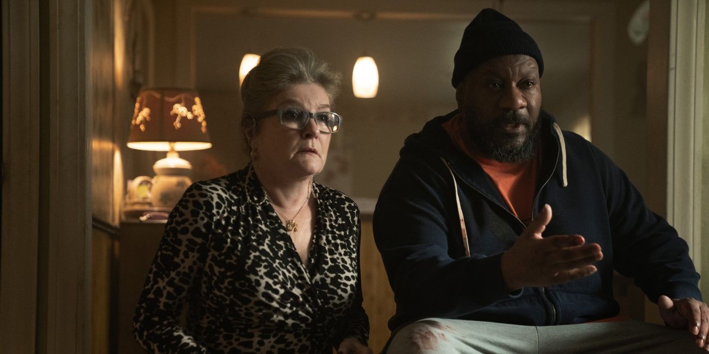 Theresa wearing a leopard print top, sitting next to Bart in a black hooded sweatshirt, in a television program Dope Thief