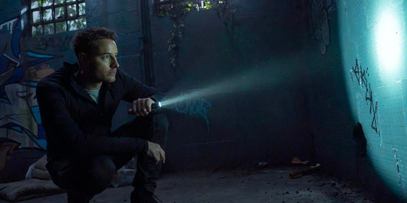 Colter shines a flashlight onto a wall showing weird symbols in Tracker.