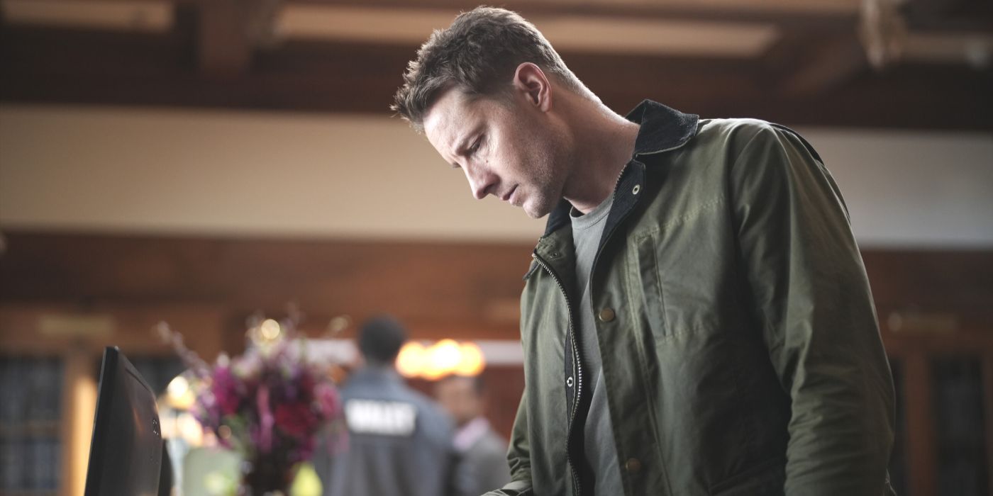 Colter Shaw (Justin Hartley), wearing a green jacket, looking down at a desk in the TV show Tracker