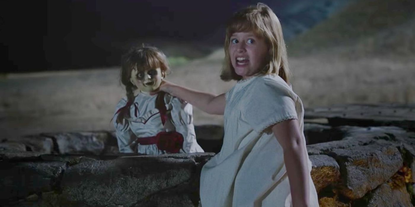 Lulu Wilson as Linda throwing the Annabelle doll into a well from the movie Annabelle: Creation (2017)