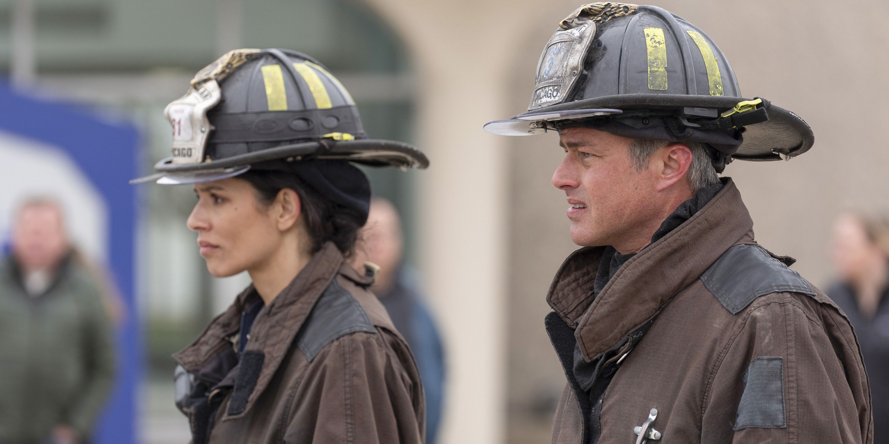 Stella and Severide wearing firefighter gear, seen in profile at crash site on Chicago Fire TV show