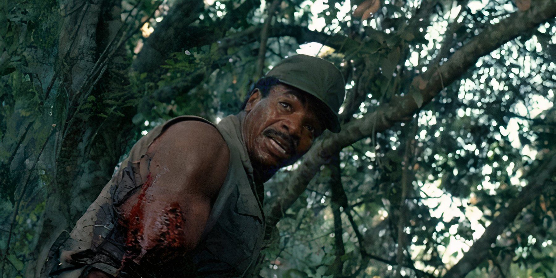 Dillon herido vagando por el bosque en Predator 1987